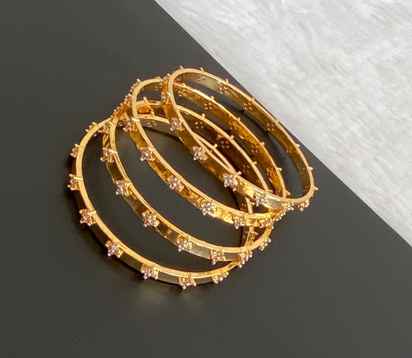 Gold tone white stone set of 4 bangles (2.4) dj-53502