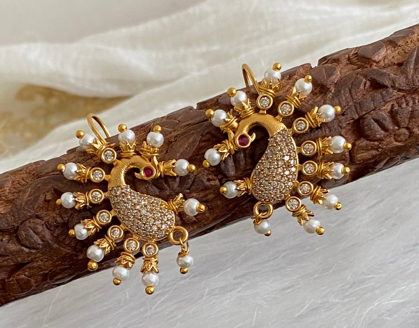 Matte gold white stone pearl peacock bugadi earrings dj-53670