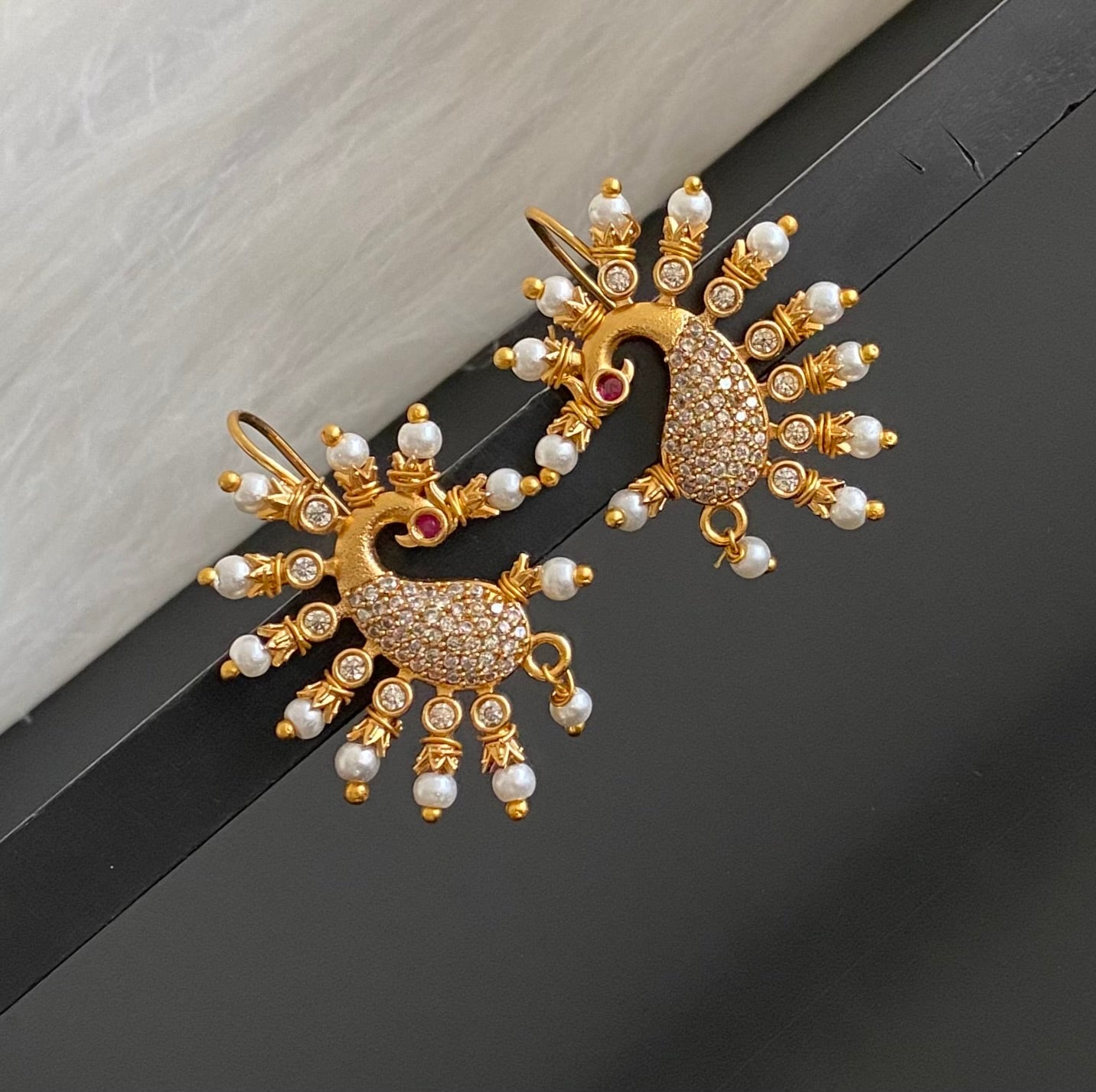 Matte gold white stone pearl peacock bugadi earrings dj-53670