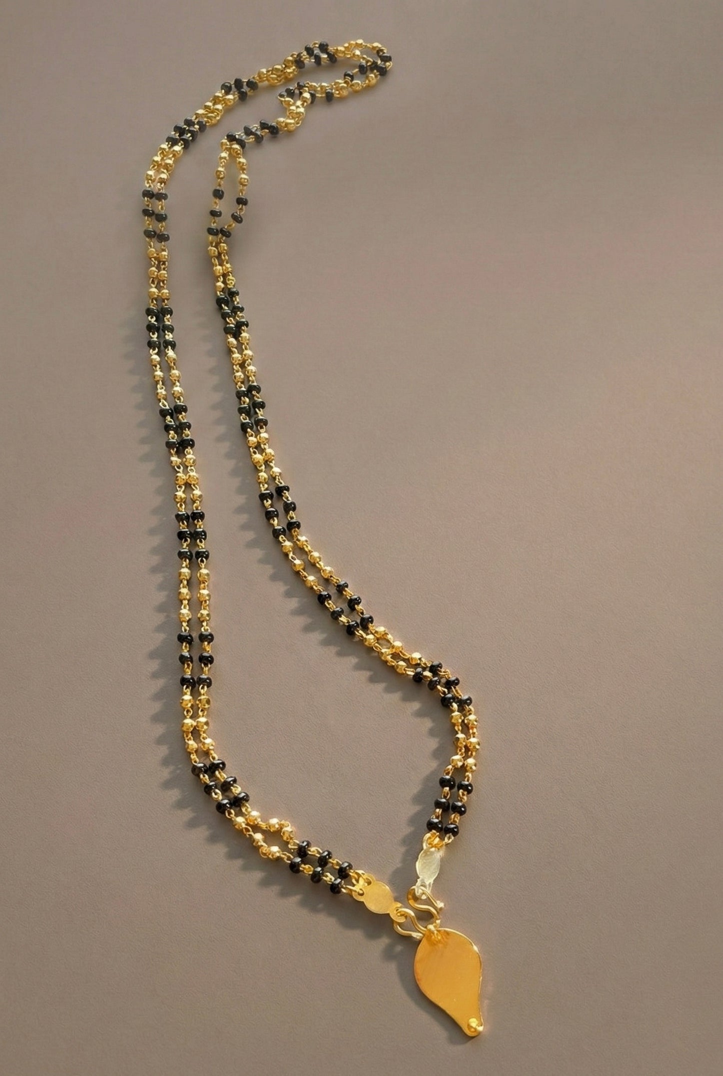 Gold tone black karimani double layer mala with elakka thali pendant dj-35567