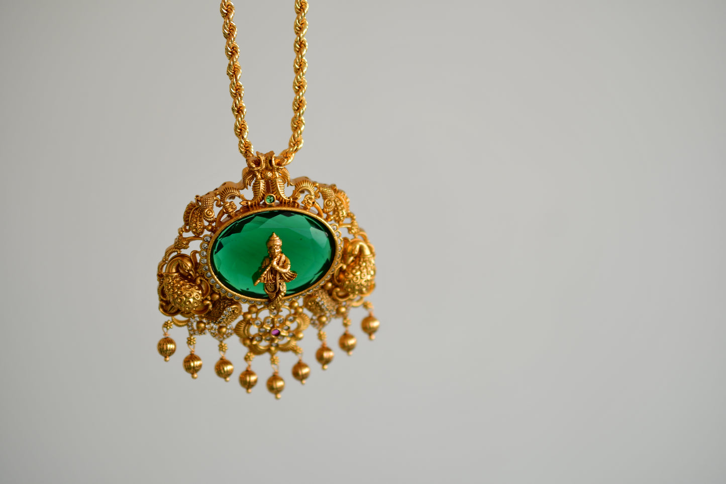 Gold tone 18 inches chain with oval green Krishna pendant dj-52615