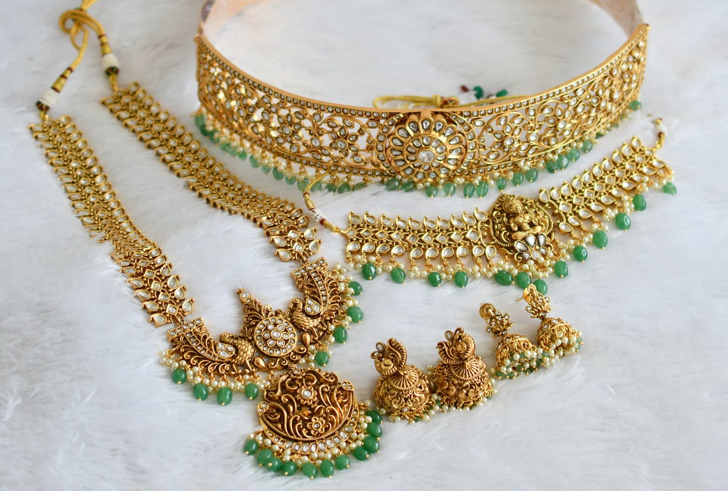 Matte finish white lakshmi-peacock-maango green beaded bridal set dj-50877