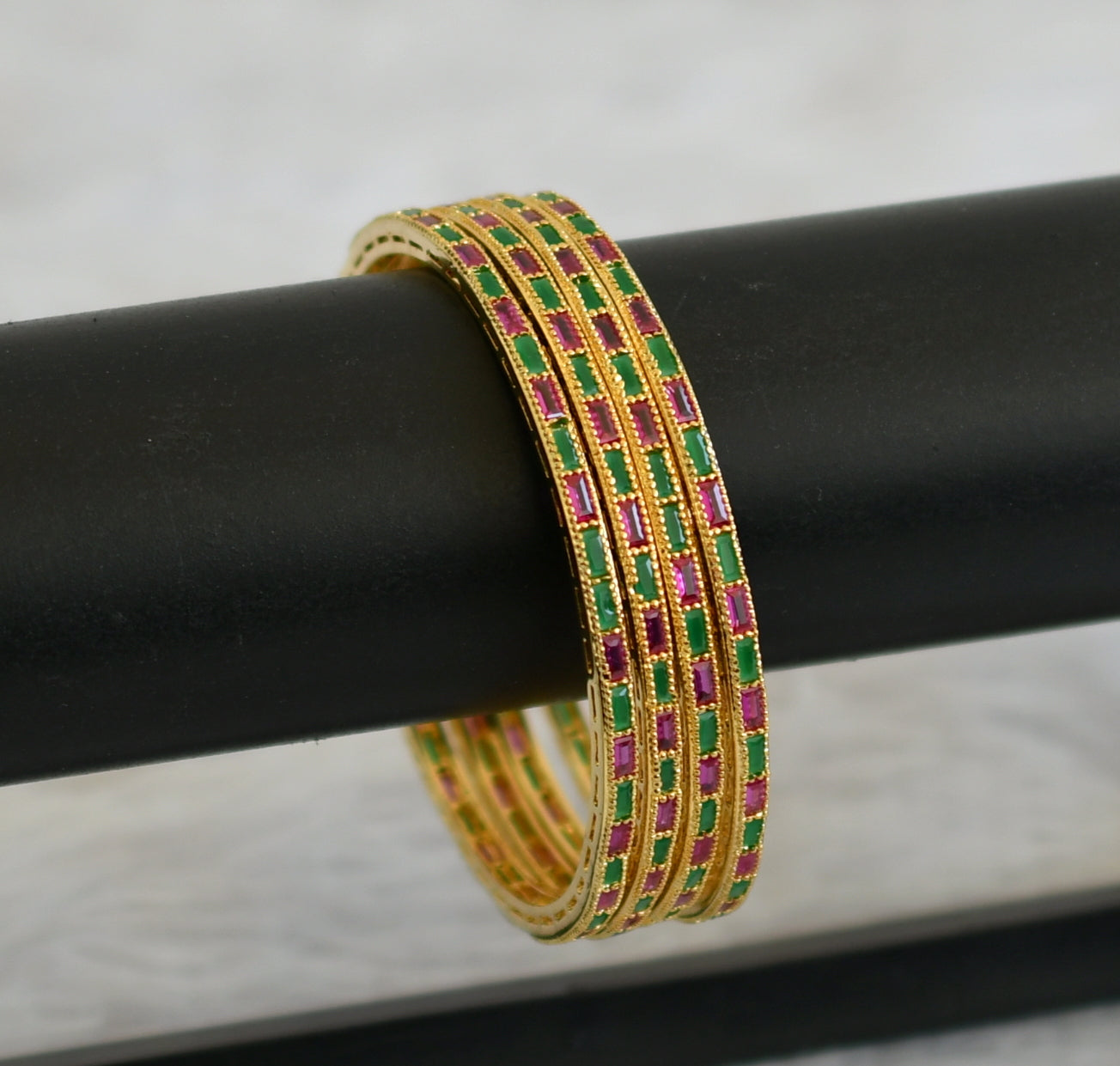 Gold tone AD set Of 4 ruby-green bangles(2.8) dj-30539