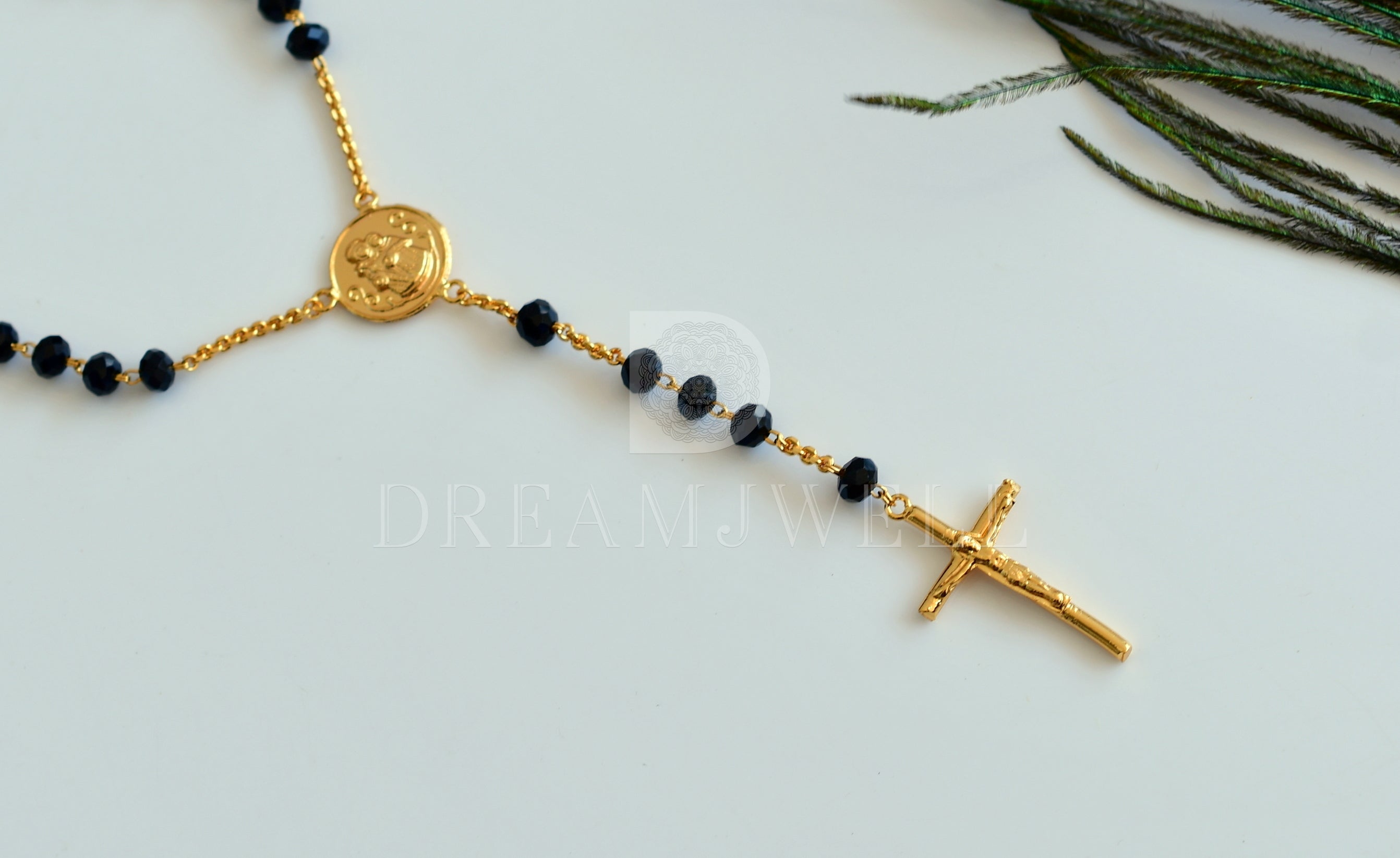 Black beaded 'Y' necklace with a cross pendant. Approximately 20