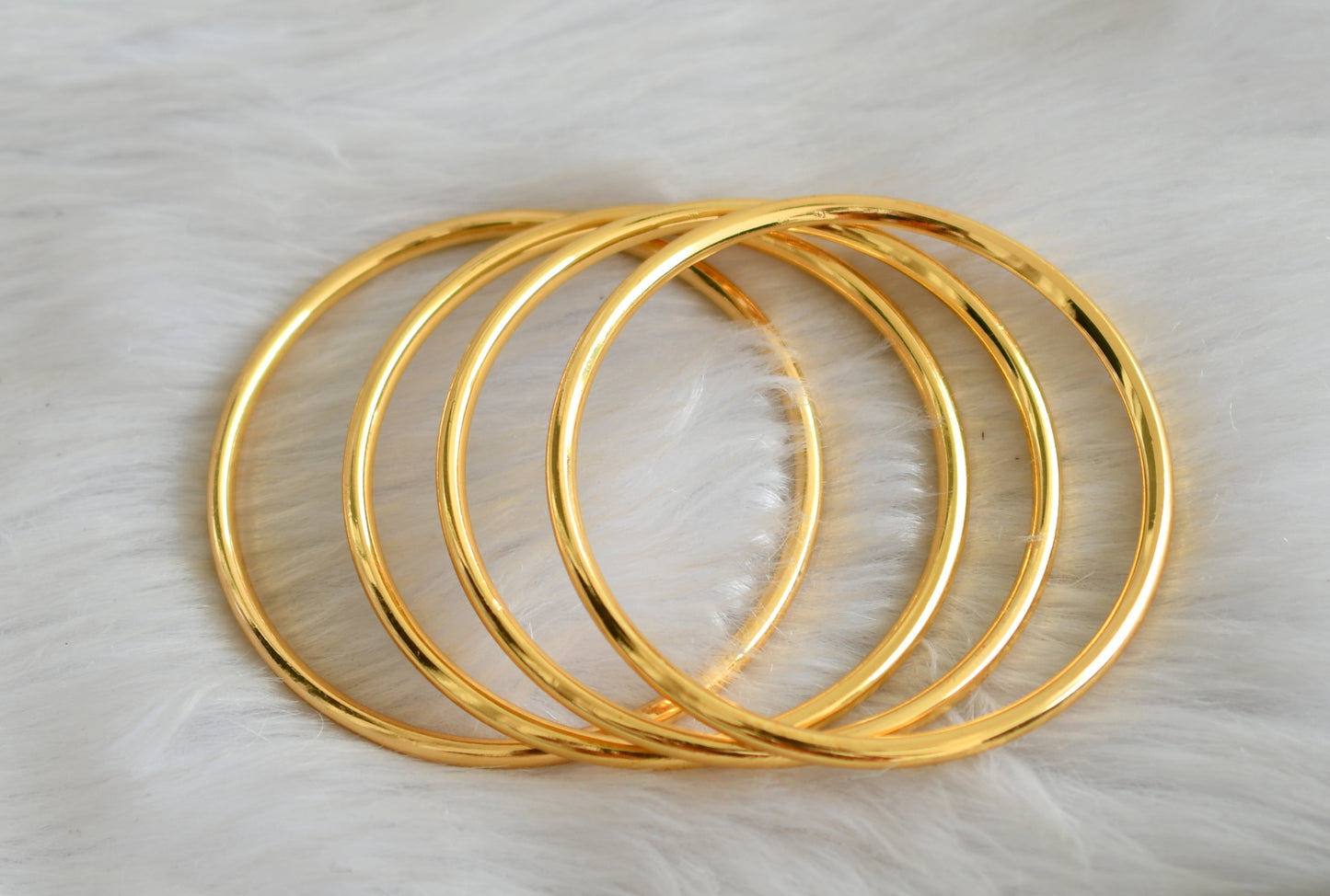 Gold Tone set of 4 thick plain Bangles(2.4) dj-33723